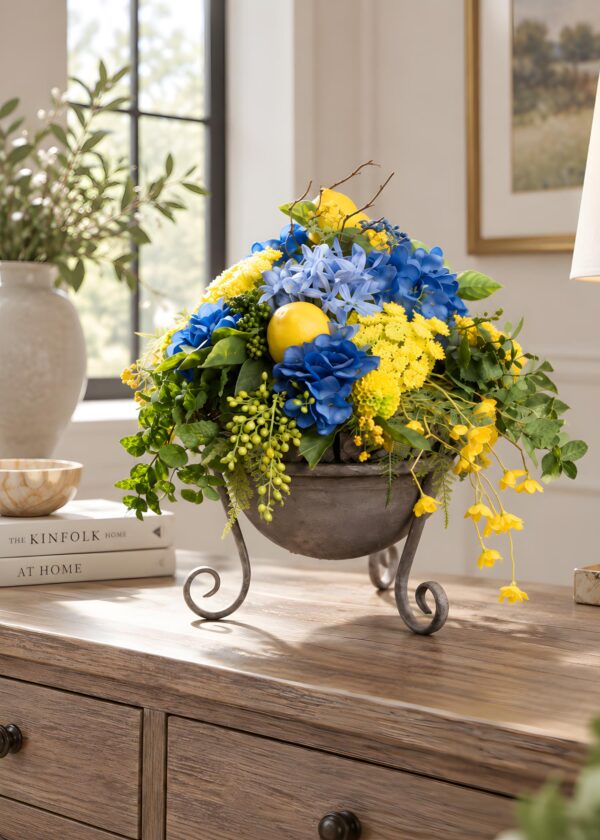 Centrotavola con fiori artificiali blu e gialli in contenitore rialzato