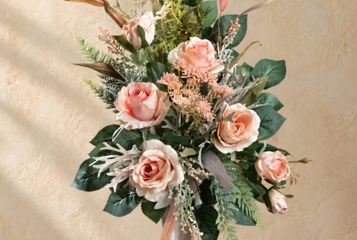 Mazzo con rose per cimitero rosa pesca visto per intero nel vaso argentato
